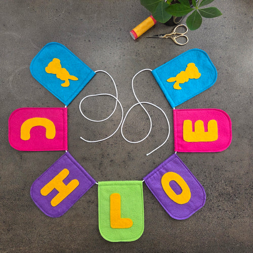 Felt banner colourful with the name CHLOE and two bunnies in yellow