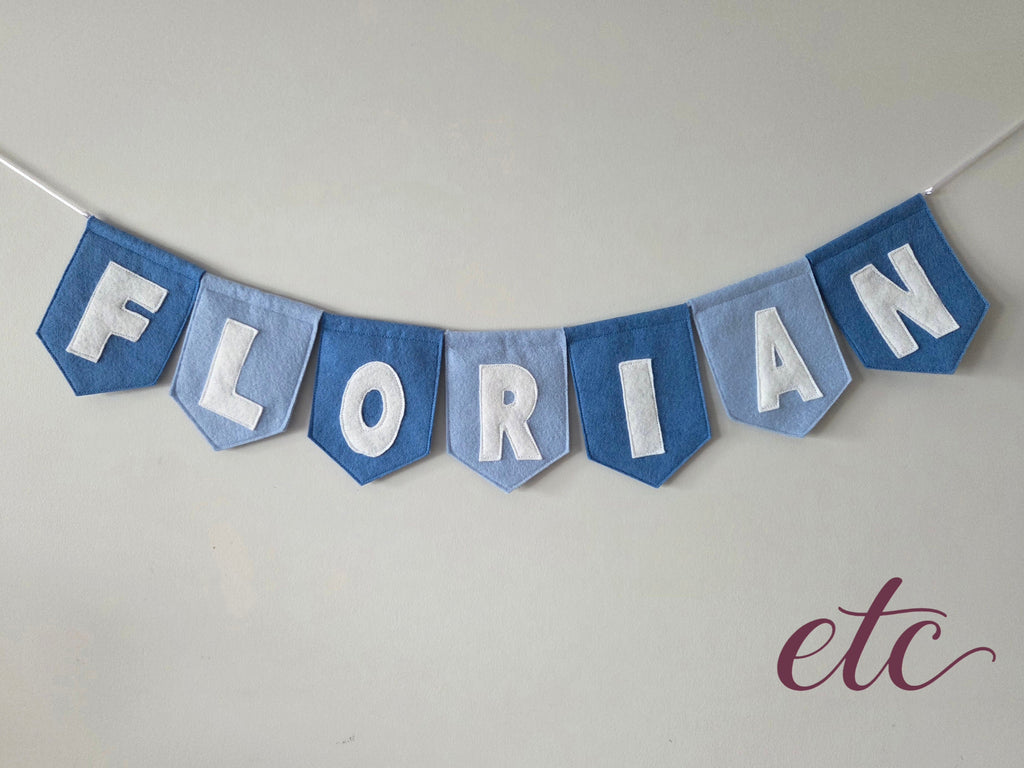 Personalised felt bunting / garland with 'Florian' letters on a plain background