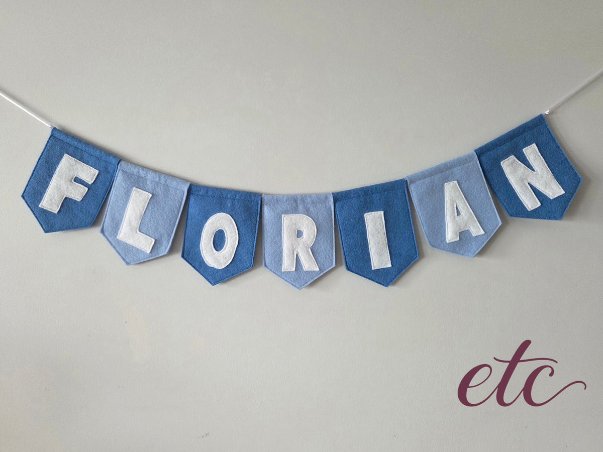 Personalised felt bunting / garland with 'Florian' letters on a plain background