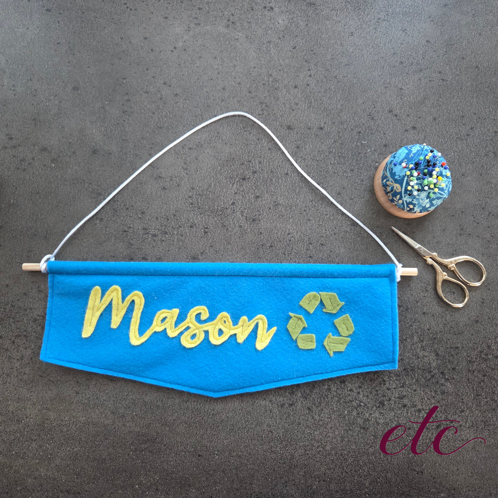 Name banner Blue with yellow name Mason and green recycling symbol 